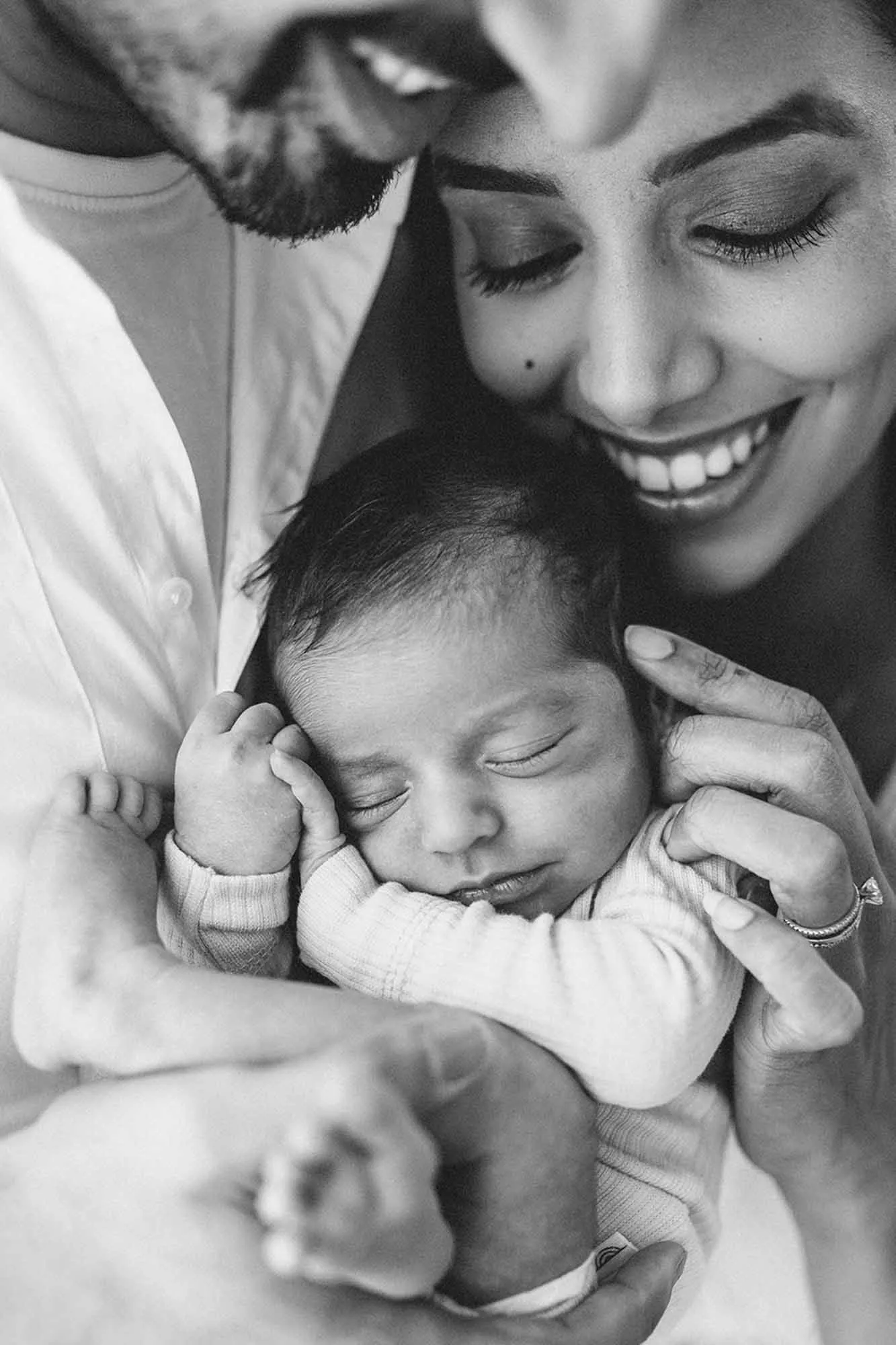 New parents holding newborn